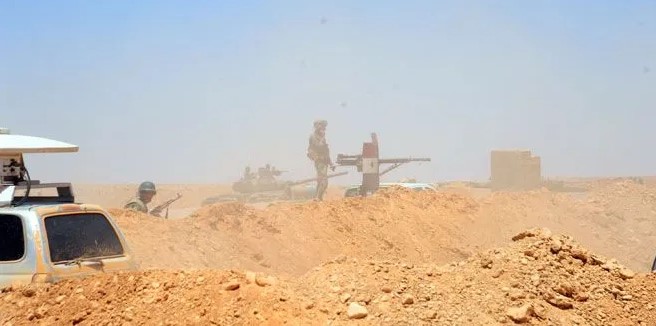 Clashes between ISIS and Syrian government forces in the Syrian Badia desert